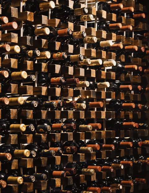 Assorted Bottles on Brown Wooden Shelf