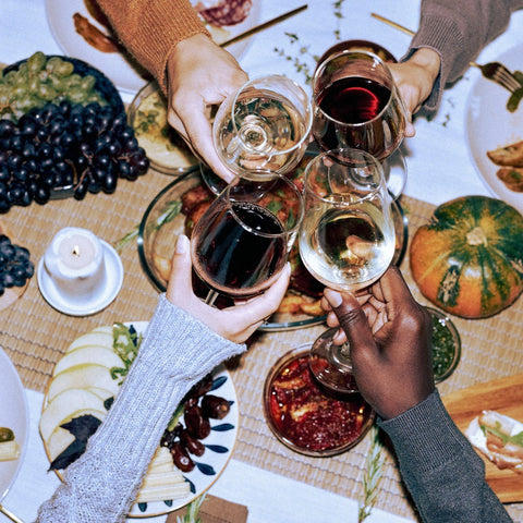 women cheers at table with california wine